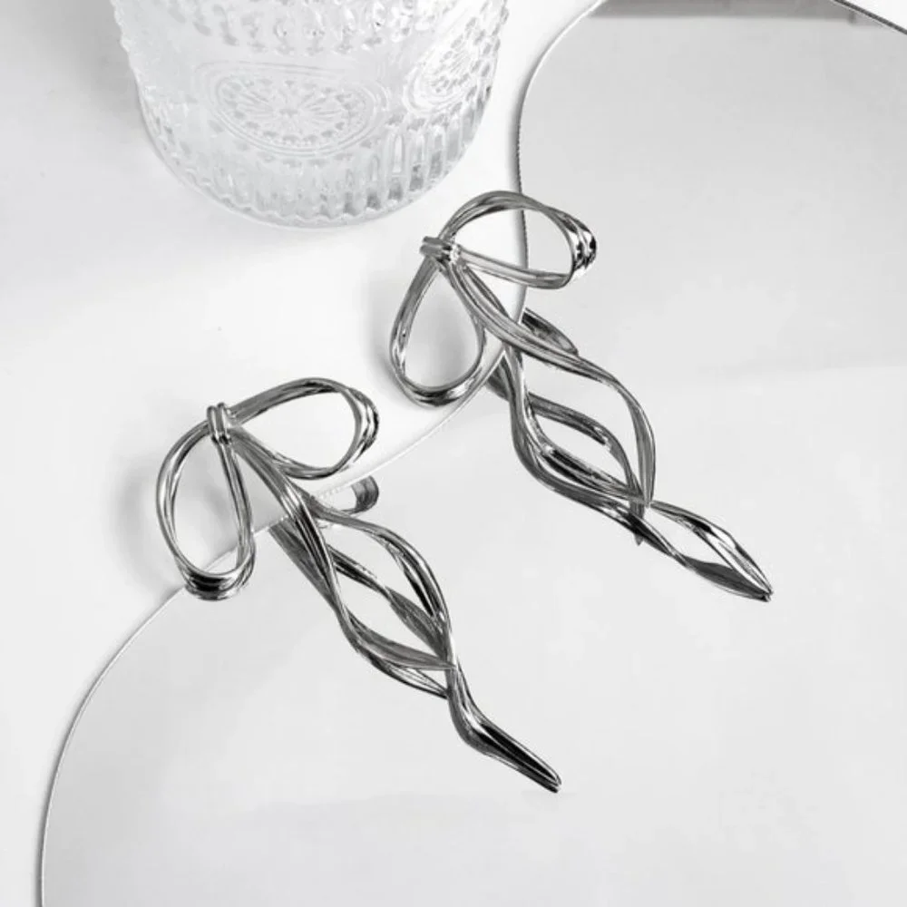 Anthro Silver Bow Earring